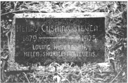 Two later stones lying flat beside vertical headstone.