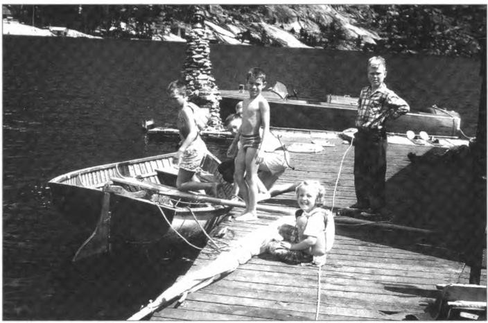 Part of Hazle's "gift" to her children: the sail boat EZ, the tall rock lighthouse, and the ever popular speed boat, the Da (Triad). And, of course, the children and friends mostly in life vests. Echo Lake circa 1951. Left to right: Bill, Jeffrey, and Linda Shurtleff, and unknown friend.