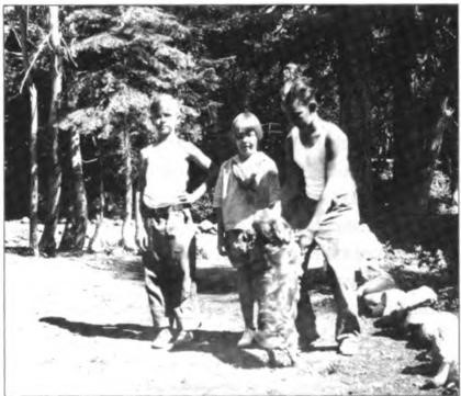 The Shurtleff kids, Gene, Nancy and Lawton, relaxing after Hazle's demanding morning work assignments, Homewood, circa 1928. The dog is a cocker spaniel named Buffie.