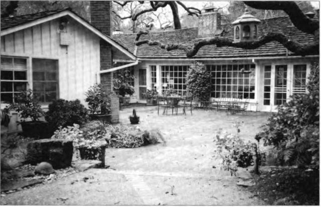 The Millers' back patio, rusti¬cally paved with bricks and lined with giant oaks. #30 Las Cascadas, Orinda, circa 1990.