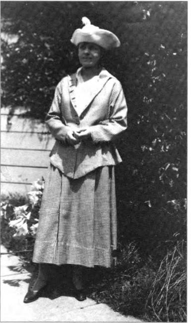 Young Helen Lawton, age 24, dressed 'to the nines," in front of the Lawton family home, 2211 Durant Avenue, Berkeley, 1916-17.