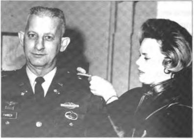 Jean Parker and her husband Chuck receiving his Gold Oak Leaves for his promotion to major in the U.S. Army, Fort Bragg, North Carolina, circa February 1970.