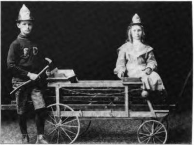 Don Lawton and youngest sister, Dorothy, with Don's handmade fire wagon, circa 1905.